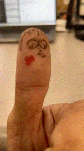 A Person 'S Finger Has A Face Drawn On It With The Letters Qq And A Heart GIF