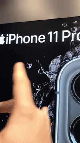 A Person 'S Finger Is Pointing At An Iphone 11 Pro Advertisement GIF