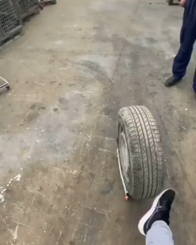 A Person 'S Foot Is On A Tire That Has A Black Stripe On It GIF