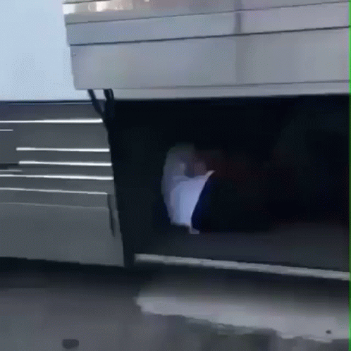 A Person 'S Foot Is Sticking Out Of The Trunk Of A Silver Vehicle GIF