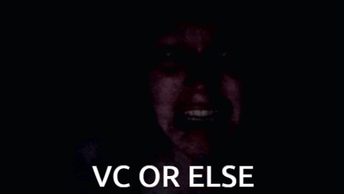 A Person 'S Hand Is Covering Their Face In The Dark With The Words `` Vc Or Else '' . GIF