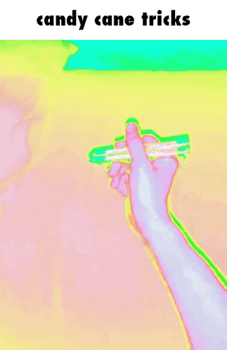 A Person 'S Hand Is Holding A Candy Cane With The Words Candy Cane Tricks Above It GIF