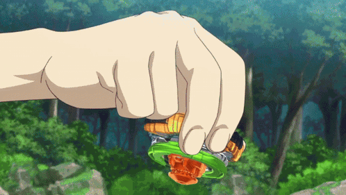 A Person 'S Hand Is Holding A Green And Orange Spinning Top GIF