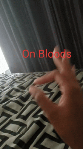 A Person 'S Hand Is Laying On A Bed With The Words " On Bloods " Above It GIF