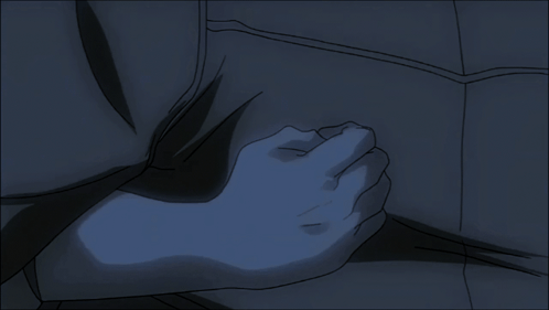 A Person 'S Hand Is On Another Person 'S Chest In A Dark Room GIF