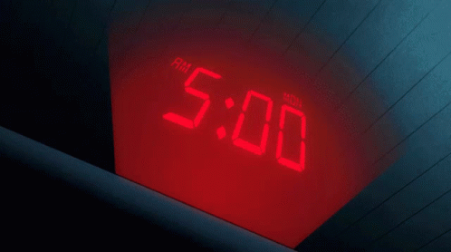 A Person 'S Hand Is Pointing At A Digital Clock That Says Am 5:40 GIF