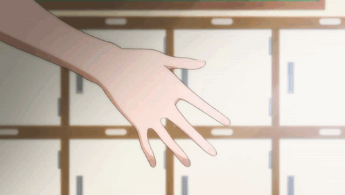 A Person 'S Hand Is Reaching Out In Front Of A Row Of Cabinets GIF