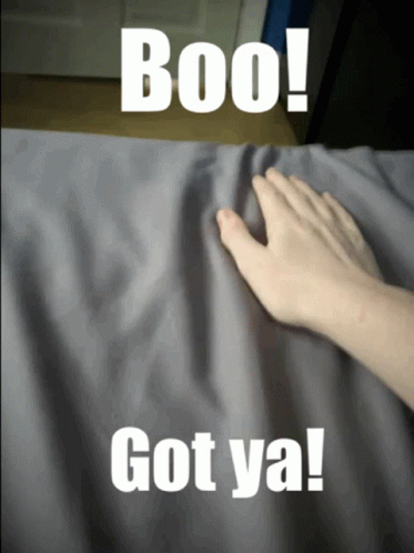 A Person 'S Hand Is Touching A Gray Cloth With The Words Boo Got Ya On It GIF