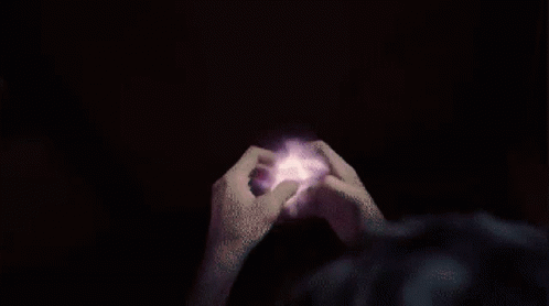A Person 'S Hands Are Reaching Out Towards A Purple And Pink Circle GIF