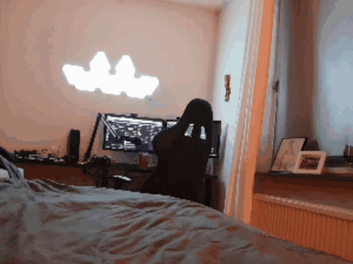 A Person Sits In A Chair In Front Of A Computer GIF