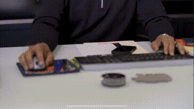 A Person Sitting At A Desk Using A Computer Mouse And Keyboard GIF