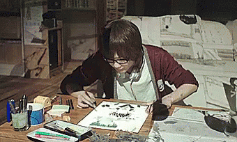 A Person Sitting At A Table With A Piece Of Paper That Says ' I ' On It GIF