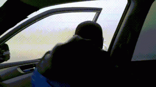 A Person Sitting In A Car Talking On A Cellphone GIF