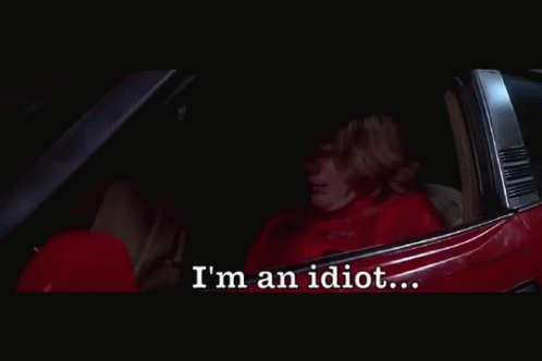 A Person Sitting In A Car With The Words I 'M An Idiot Below Them GIF