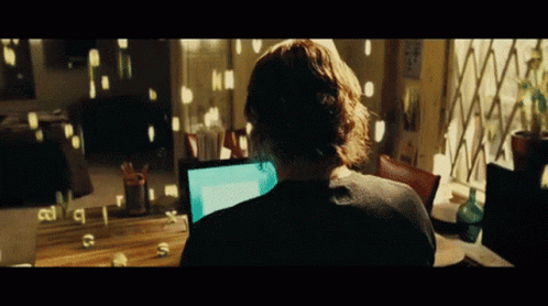 A Person Sitting In Front Of A Computer With The Letters C And S Visible On The Screen GIF