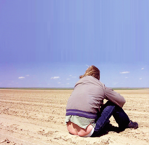 A Person Sitting In The Dirt With Their Butt Showing GIF