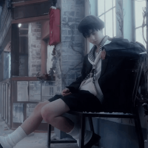 A Person Sitting On A Chair With A Backpack On The Back GIF