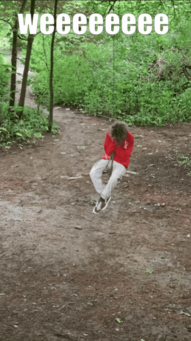 A Person Sitting On A Swing In The Woods With The Words Weeeeeeee Written Above Them GIF