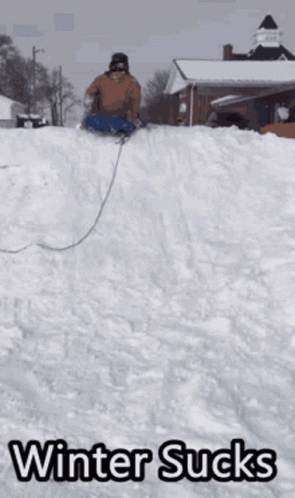 A Person Sledding Down A Snowy Hill With The Words Winter Sucks Written Below Them GIF