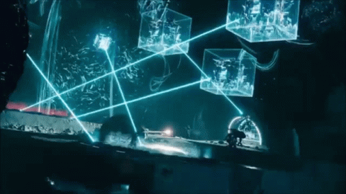 A Person Standing In A Dark Room With A Bunch Of Glowing Boxes In The Background GIF