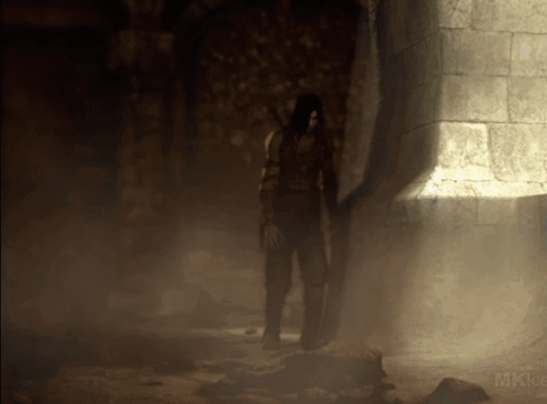 A Person Standing In A Dark Room With The Word Mk On The Bottom Left GIF