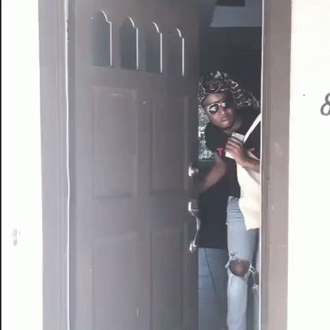 A Person Standing In A Doorway With The Number 8 On It GIF