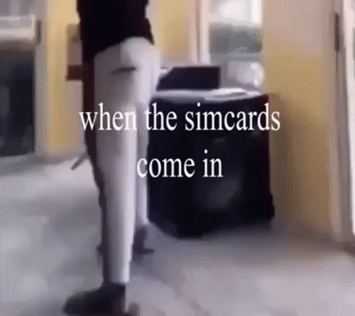 A Person Standing In A Room With The Words " When The Simcards Come In " GIF