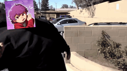 A Person Standing In Front Of A Brick Wall With A Picture Of A Girl Behind Them GIF