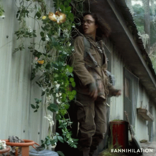 A Person Standing In Front Of A Building With The Hashtag #Annihilation On The Bottom GIF