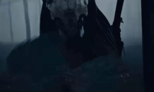 A Person Standing In The Dark With A Sword GIF
