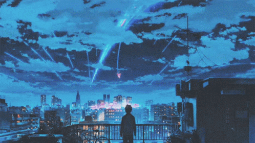 A Person Standing On A Building Looking Up At The Sky GIF