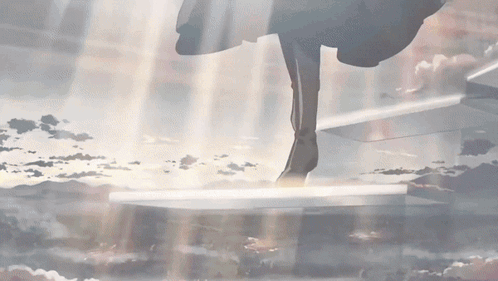 A Person Standing On A Staircase With The Sun Shining Through GIF