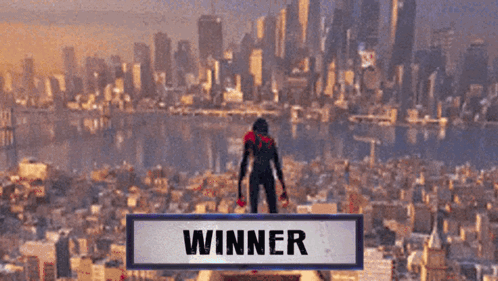 A Person Standing On Top Of A Building With The Word Winner Above Them GIF