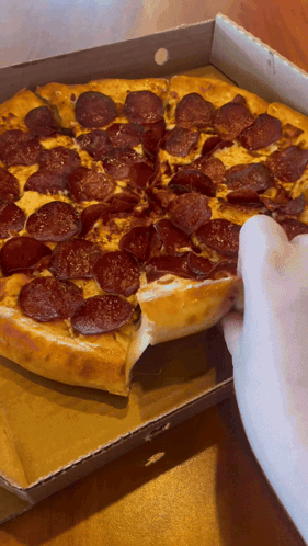 A Person Taking A Slice Of Pepperoni Pizza Out Of A Cardboard Box GIF