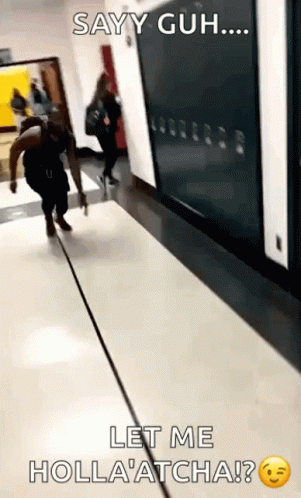 A Person Walking Down A Hallway With The Caption Sayy Guh Let Me Holla Atcha ? GIF