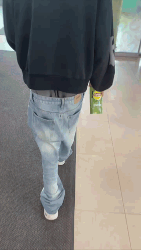 A Person Walking With A Bag Of Lays Chips In Their Hand GIF