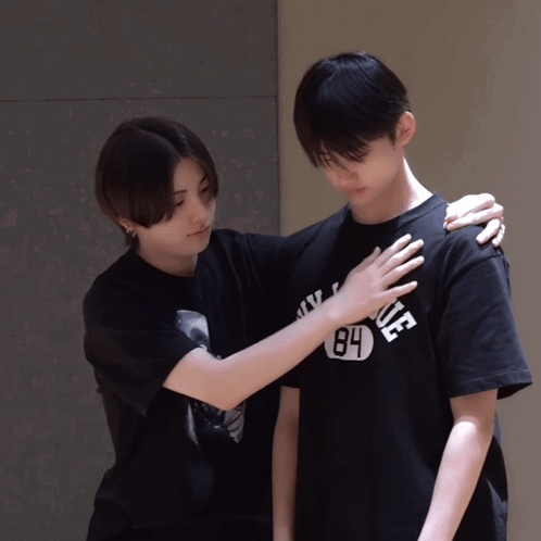 A Person Wearing A 84 T-Shirt Holds Another Person 'S Shoulder GIF