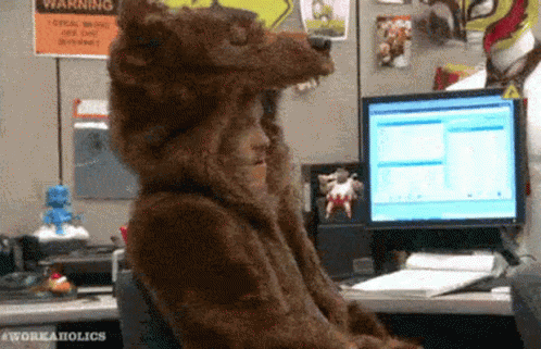A Person Wearing A Bear Costume Is Sitting In Front Of A Computer GIF