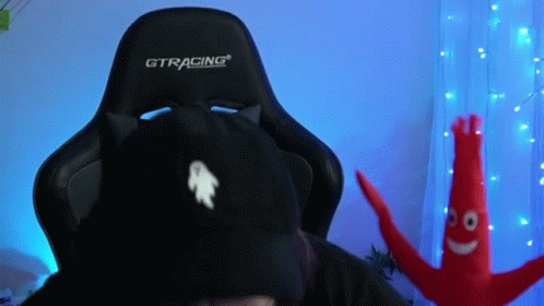 A Person Wearing A Black Cat Hat Is Sitting In A Gtracing Gaming Chair . GIF