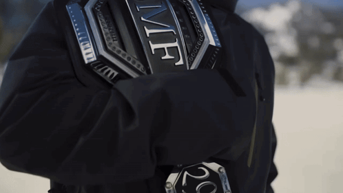 A Person Wearing A Black Jacket With A Silver Emblem On The Back That Says ' Ufc ' GIF