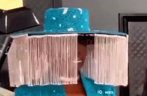A Person Wearing A Blue Hat With A White Fringe On It . GIF