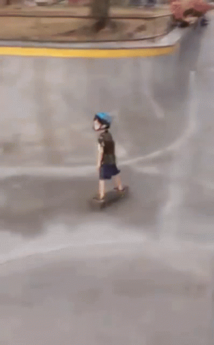 A Person Wearing A Blue Helmet Rides A Skateboard Down A Ramp GIF