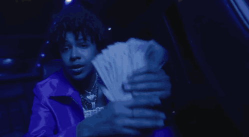 A Person Wearing A Blue Jacket And A Necklace That Says Spkp GIF