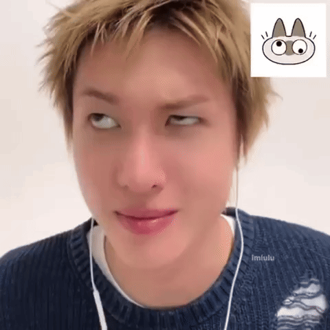 A Person Wearing A Blue Sweater And Earphones Making A Face GIF