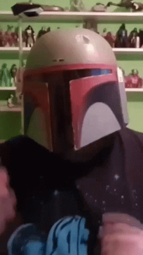 A Person Wearing A Boba Fett Helmet And A Star Wars T-Shirt GIF