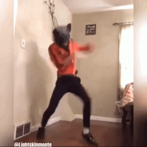 A Person Wearing A Cat Mask Is Dancing In A Room With Lightsskinmonte Written On The Bottom GIF