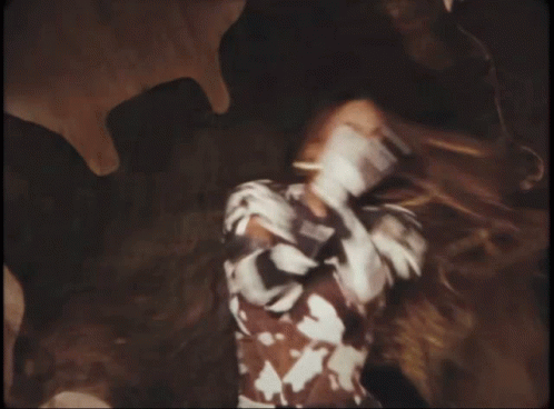 A Person Wearing A Cow Print Shirt With The Letters S On It GIF