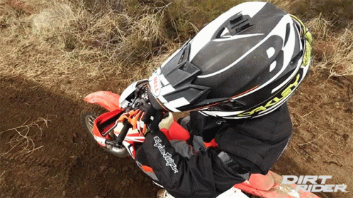 A Person Wearing A Dirt Rider Helmet Is Riding A Dirt Bike GIF