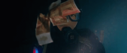 A Person Wearing A Gas Mask And Goggles Is Holding A Bunch Of Money In Front Of Their Face . GIF