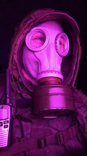 A Person Wearing A Gas Mask Next To A Walkie Talkie That Says Sony GIF